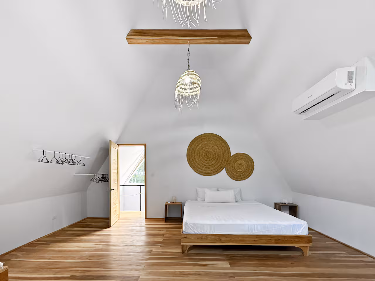Bedroom interior with natural wood finishes and jungle views