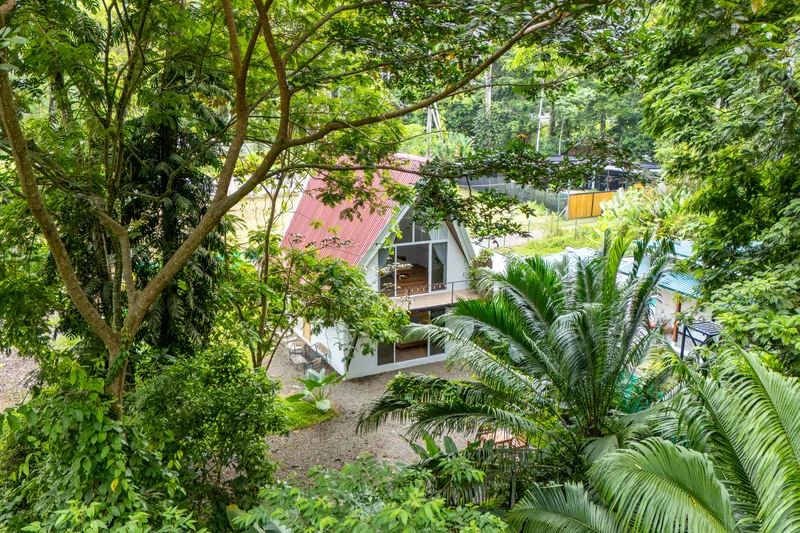 Crystal Jungle Villa A-frame seen through the jungle canopy from above